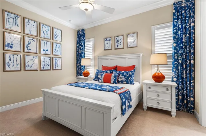 Bedroom featuring light carpet, multiple windows, ornamental molding, and ceiling fan