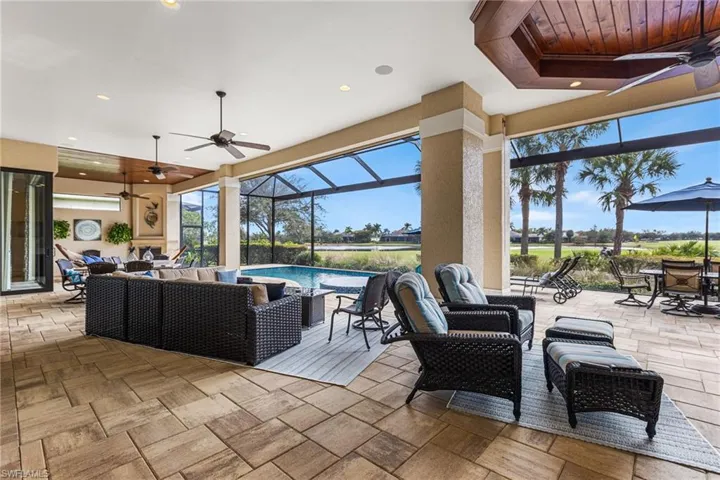 View of patio / terrace with outdoor lounge area, ceiling fan, and glass enclosure