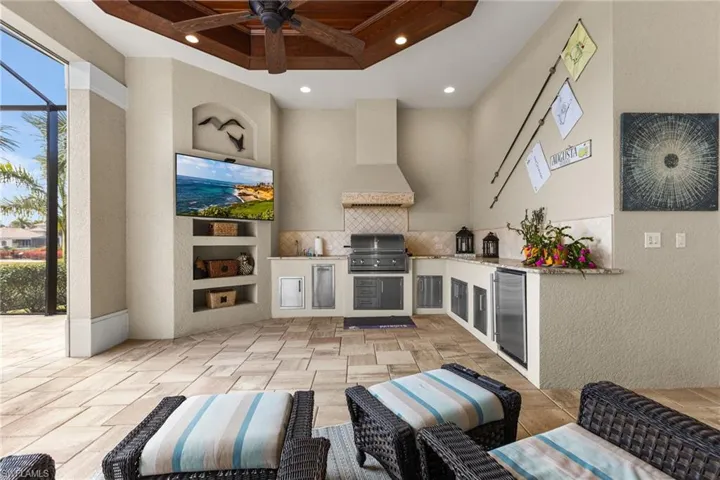 View of patio with an outdoor kitchen, area for grilling, and ceiling fan