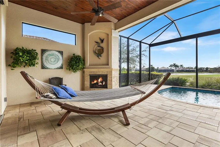 View of patio / terrace with a premium fireplace and ceiling fan