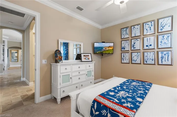 Bedroom with crown molding and ceiling fan