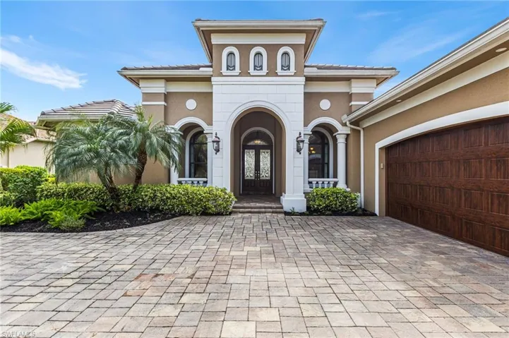 View of front facade with a garage and french doors