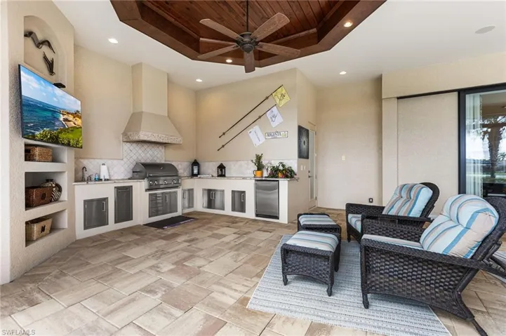 View of patio / terrace featuring ceiling fan, a grill, exterior kitchen, and sink