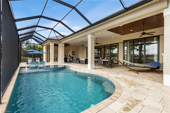 View of swimming pool with an outdoor living space, a lanai, a patio, and ceiling fan