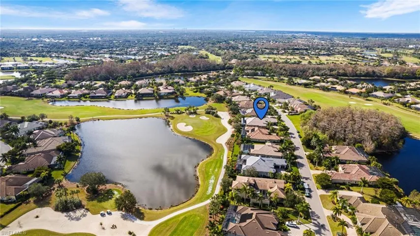 Birds eye view of property with a water view