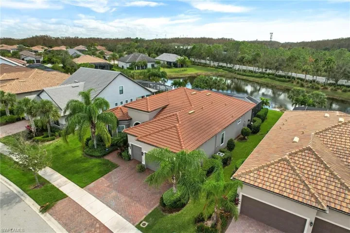Birds eye view of property with a water view