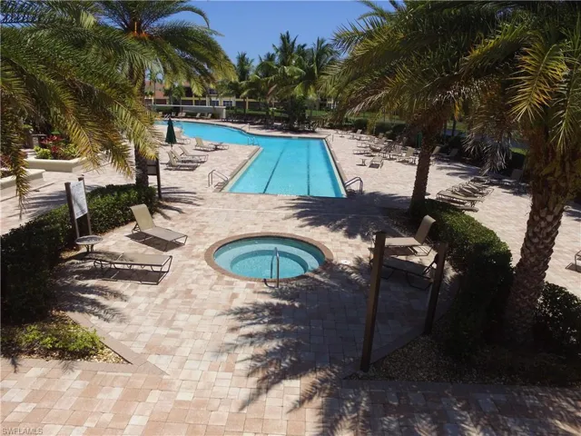 View of pool with a community hot tub and a patio area