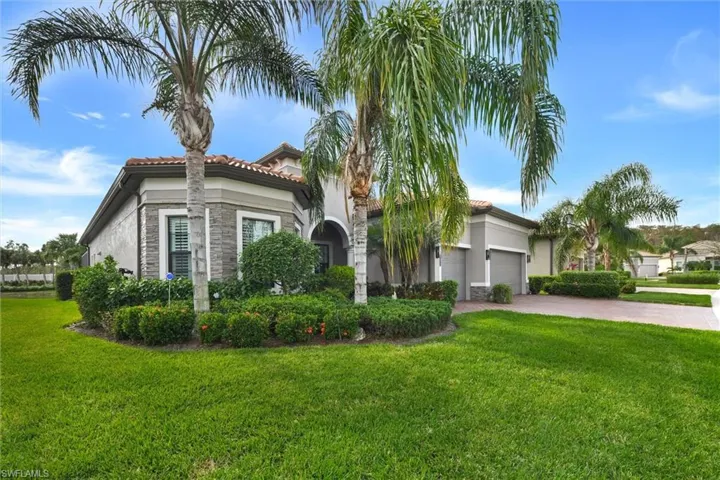 Mediterranean / spanish-style home with a front yard and a garage