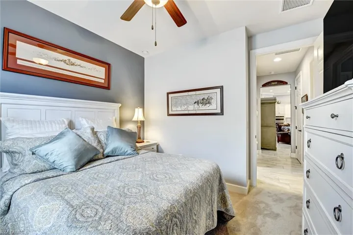 Bedroom with light carpet and ceiling fan