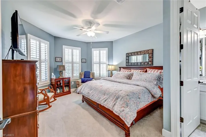 Carpeted bedroom with ceiling fan