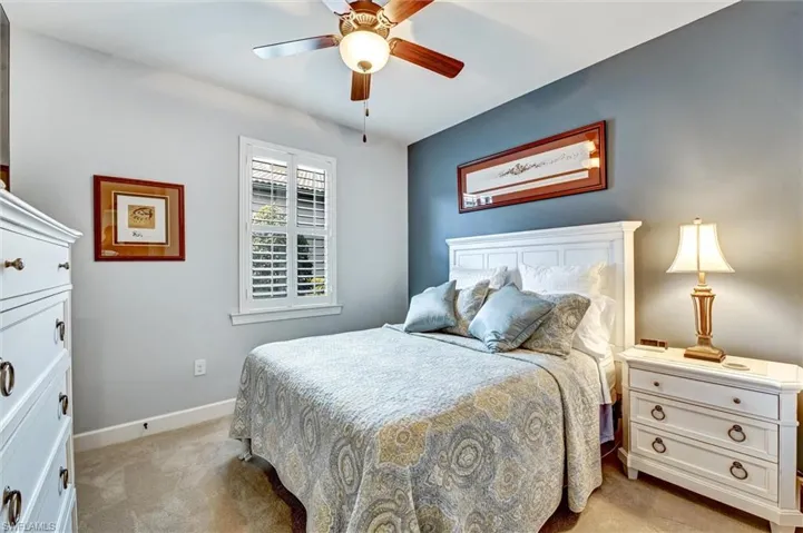 Carpeted bedroom with ceiling fan