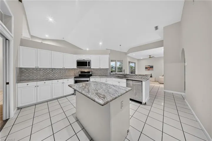 Bright open kitchen: granite counters, stainless appliances (new microwave & dishwasher), center island, and pull-outs in every lower cabinet.Bright open kitchen: granite counters, stainless appliances (new microwave & dishwasher), center island, and pull-outs in every lower cabinet.