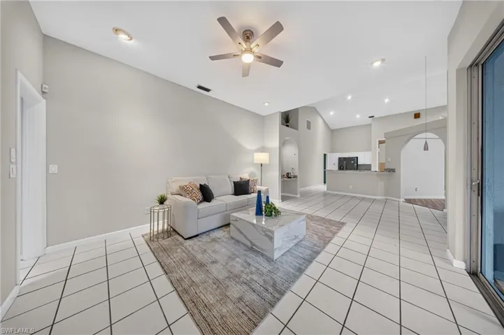 Soaring vaulted great room with all-new laminate flooring and LED dimmable lighting, flowing seamlessly to the kitchen.