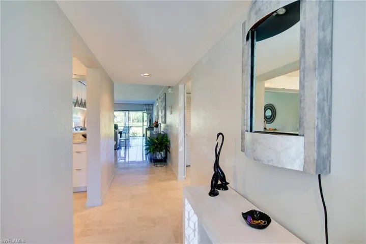 Hallway featuring recessed lighting and baseboards