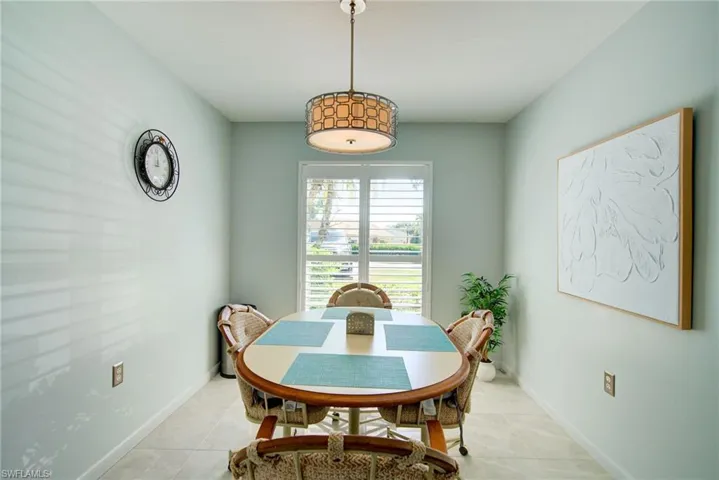 Tiled dining room featuring baseboards