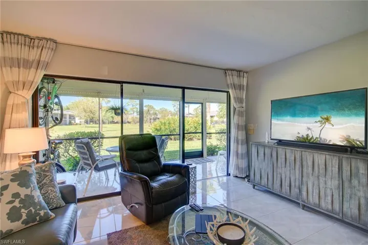 Living room featuring plenty of natural light and tile patterned floors