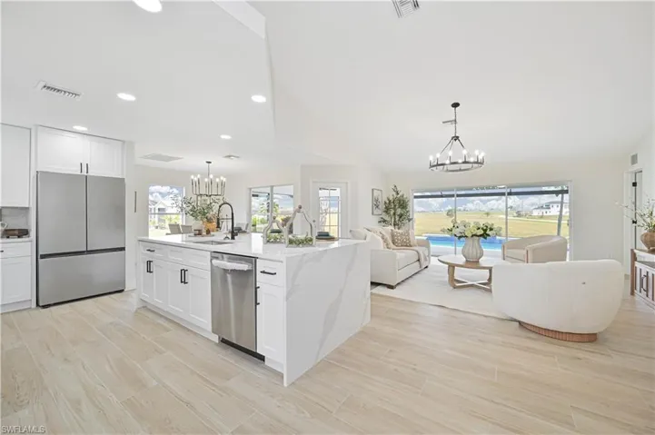 phenomenal kitchen overlooking the living room and pool area