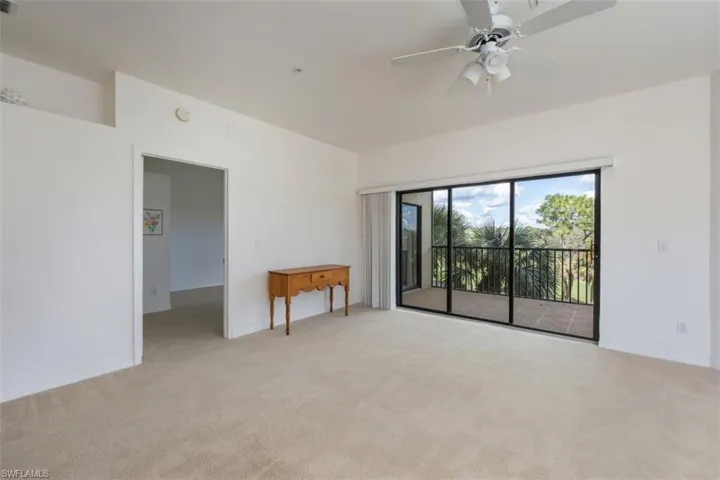 Empty room with light carpet and ceiling fan