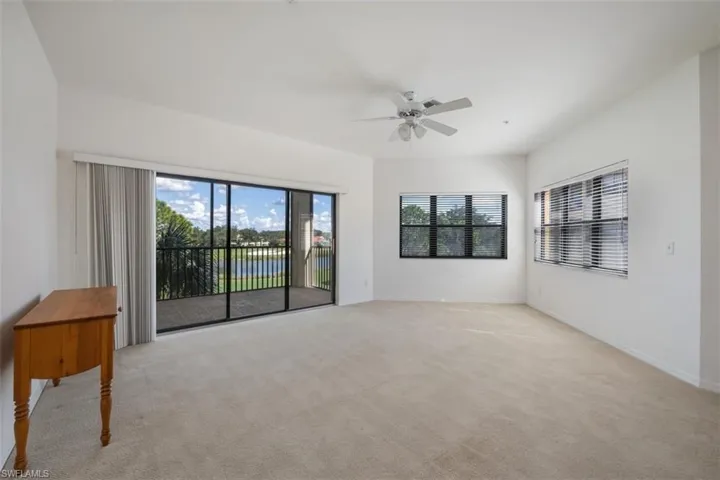 Empty room featuring light colored carpet and ceiling fan