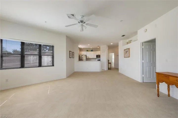 Unfurnished living room with light carpet, recessed lighting, and a ceiling fan