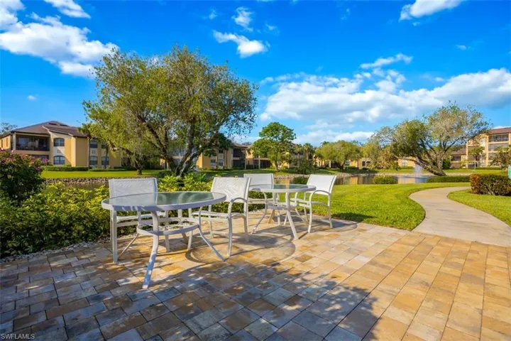 View of patio / terrace featuring outdoor dining space, a water view, and a residential view