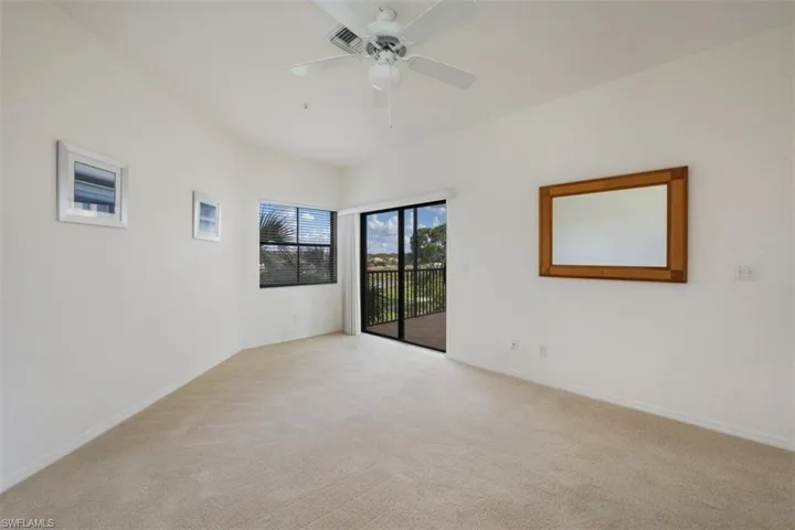 Spare room with light colored carpet and a ceiling fan