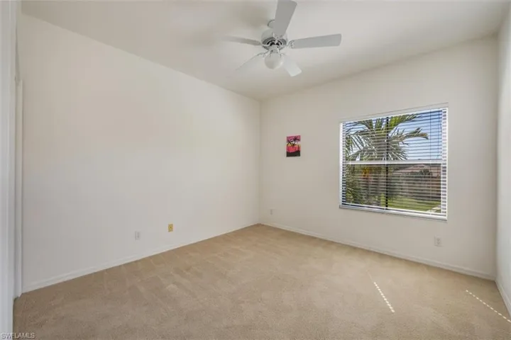 Spare room with light colored carpet and ceiling fan