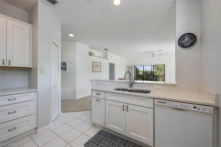 Kitchen featuring dishwasher, white cabinetry, a peninsula, light tile patterned floors, and recessed lighting