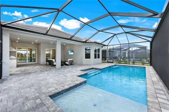 Outdoor pool with a sunroom, a lanai, and a patio