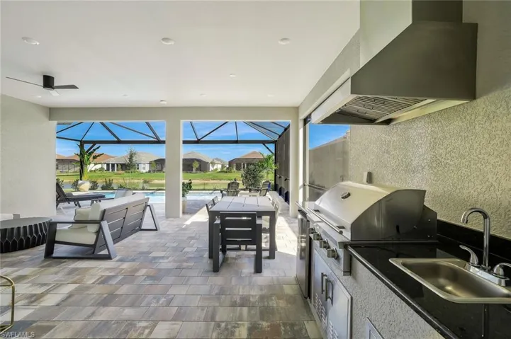 View of patio with a sunroom, a residential view, an outdoor pool, and a lanai