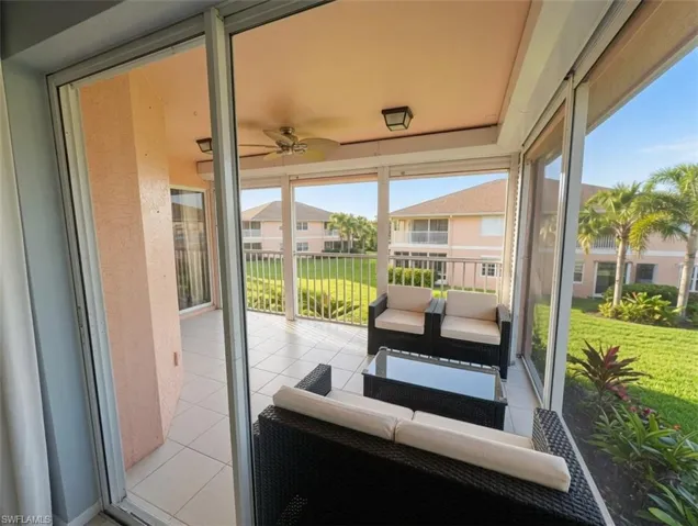 Screened lanai featuring tile flooring, a ceiling fan, and recessed lighting