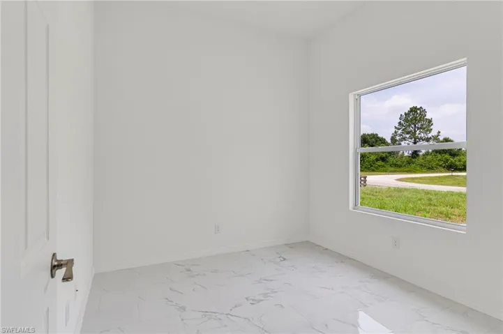 Unfurnished room featuring light tile flooring