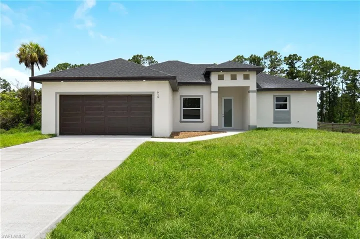 Prairie-style house featuring a garage and a front lawn