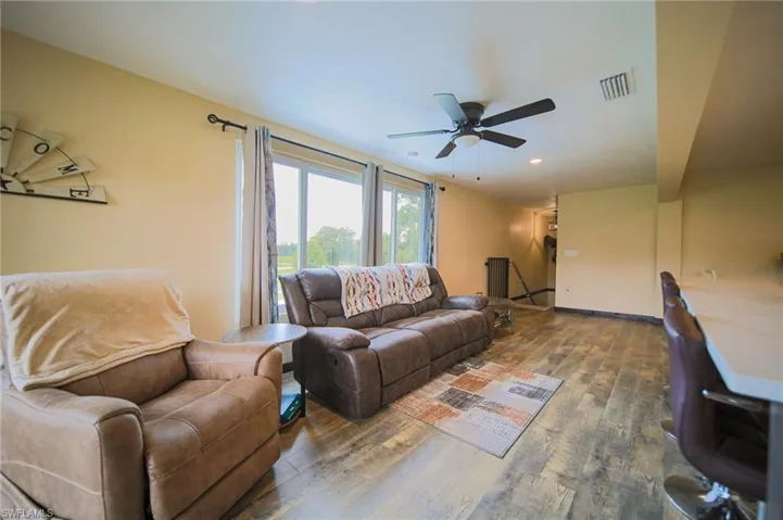 Living room with wood finished floors and a ceiling fan