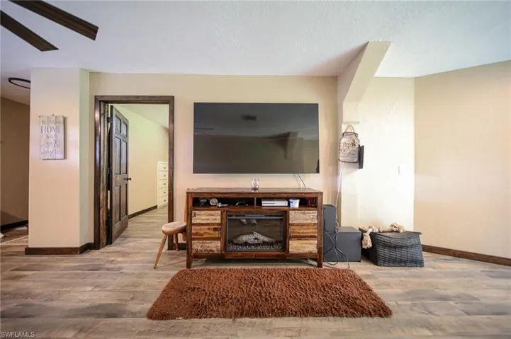Living area with wood finished floors and a textured ceiling