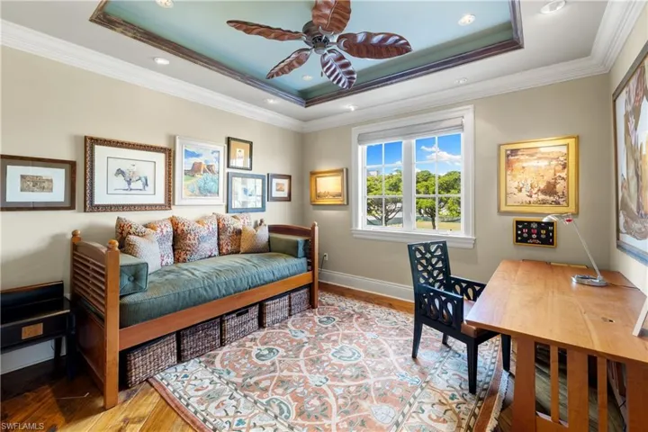 Recessed ceiling with decorative tray detail and a central chandelier