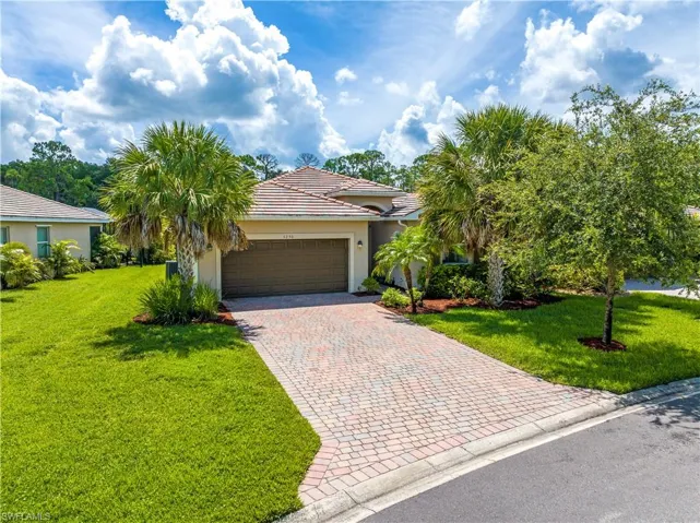 View of front of home featuring a garage and a front yard