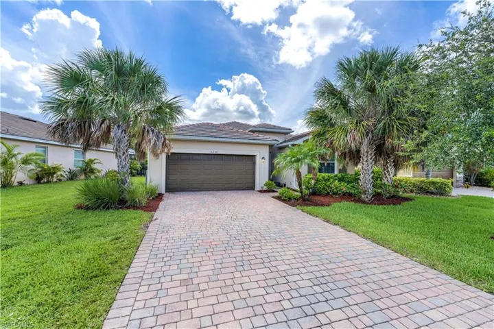 View of front of home featuring a garage and a front lawn