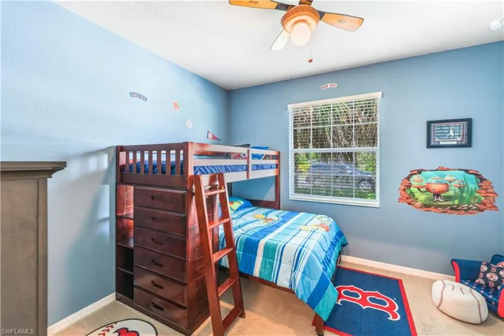 Bedroom featuring light colored carpet and ceiling fan