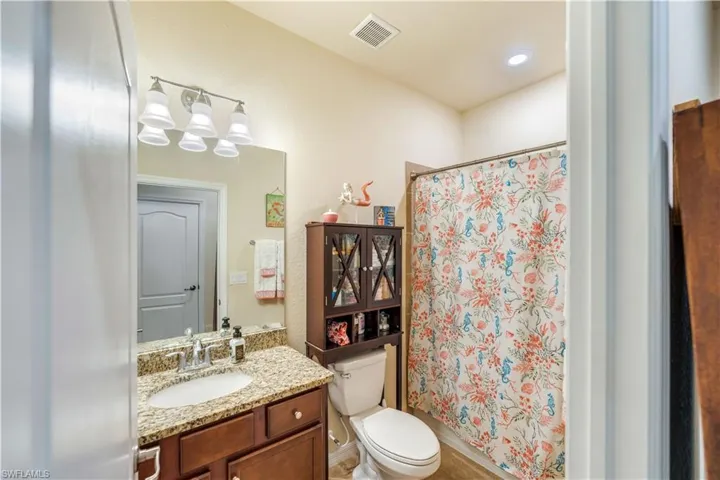 Bathroom featuring vanity and toilet