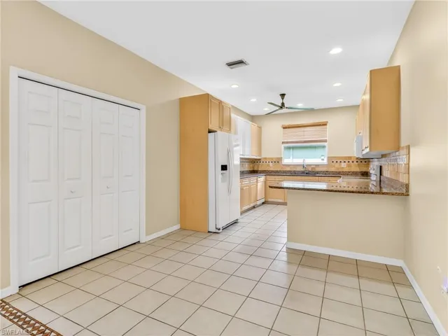 Kitchen featuring granite countertops, and a tiled backsplash