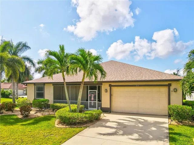 Single-story residence featuring a stucco exterior, an attached two-car garage with a panel door, and a screened front entry
