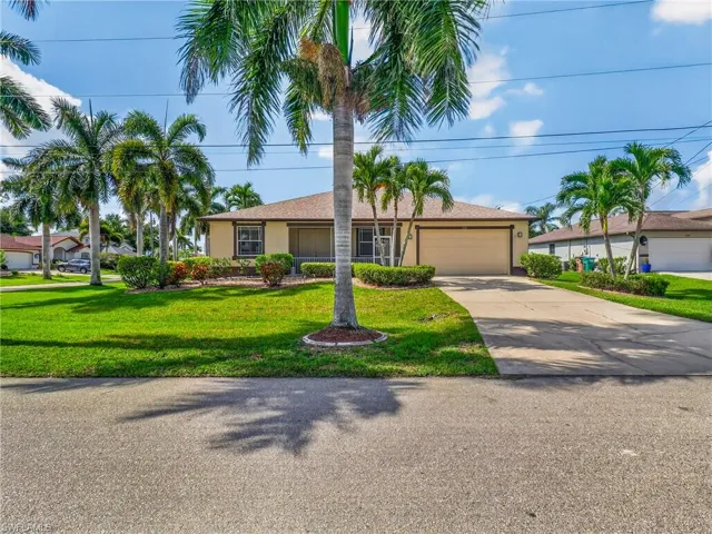 Single-story residence featuring a two-car garage, concrete driveway, and a shingle roof