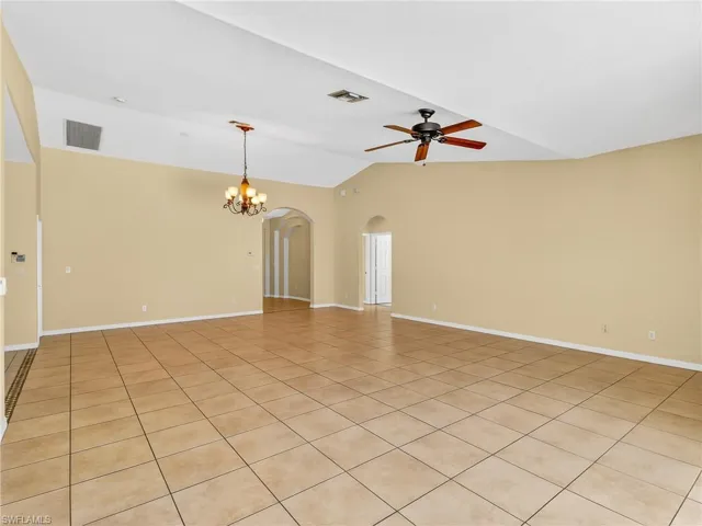 Spacious interior with neutral wall tones and  tile flooring