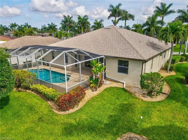 Screened lanai enclosing a swimming pool with integrated spa