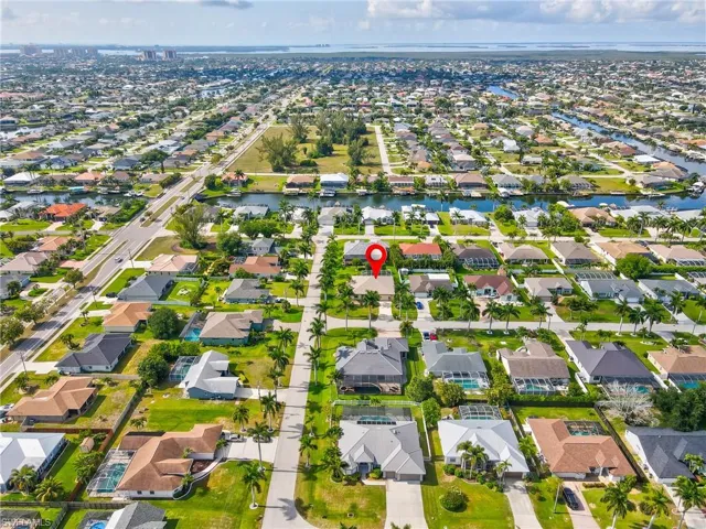 Aerial perspective showcasing a residential neighborhood with canal access