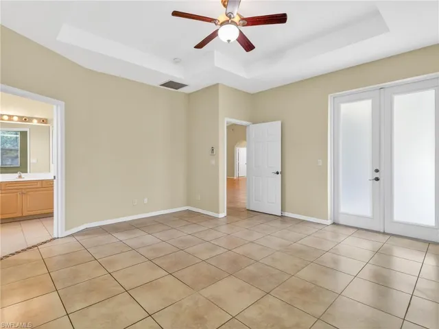 Spacious room featuring neutral tone walls and large format tile flooring