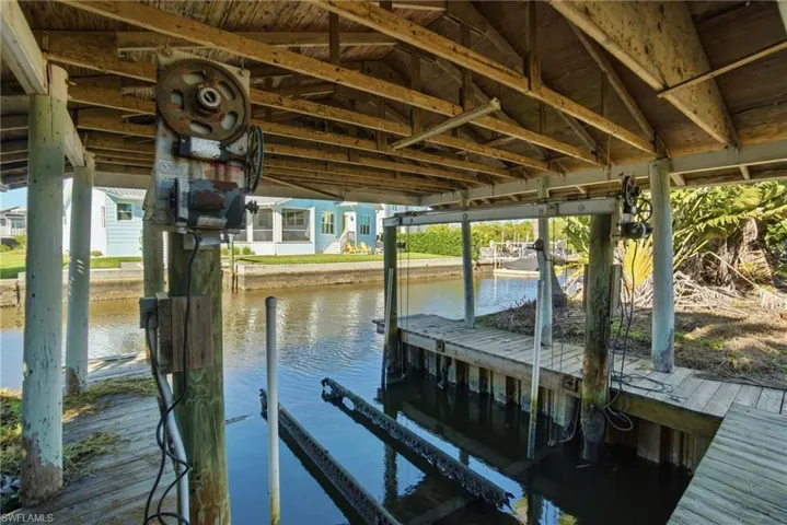 Dock area featuring a water view and boat lift