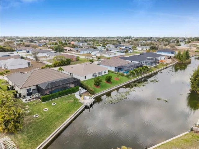 Aerial view of residential area featuring a large body of water