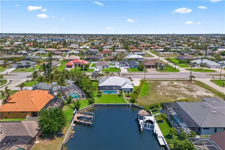 Birds eye view of property featuring a water view and a residential view